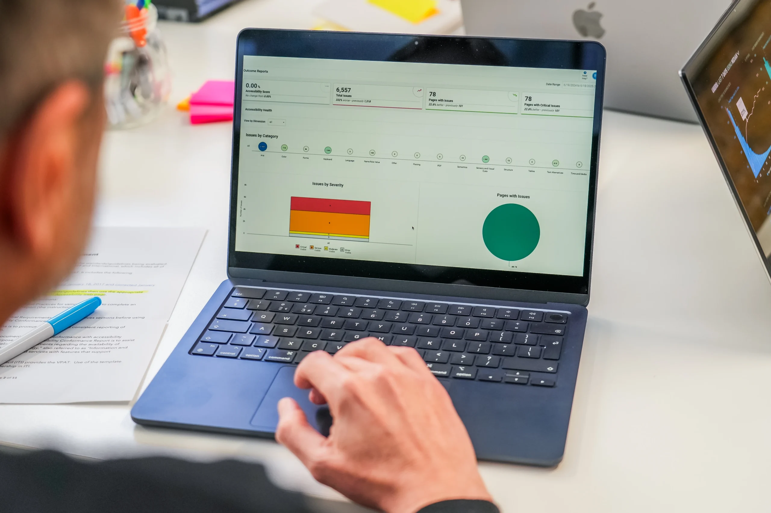 Person reviewing an accessibility report with charts and metrics on a laptop screen.