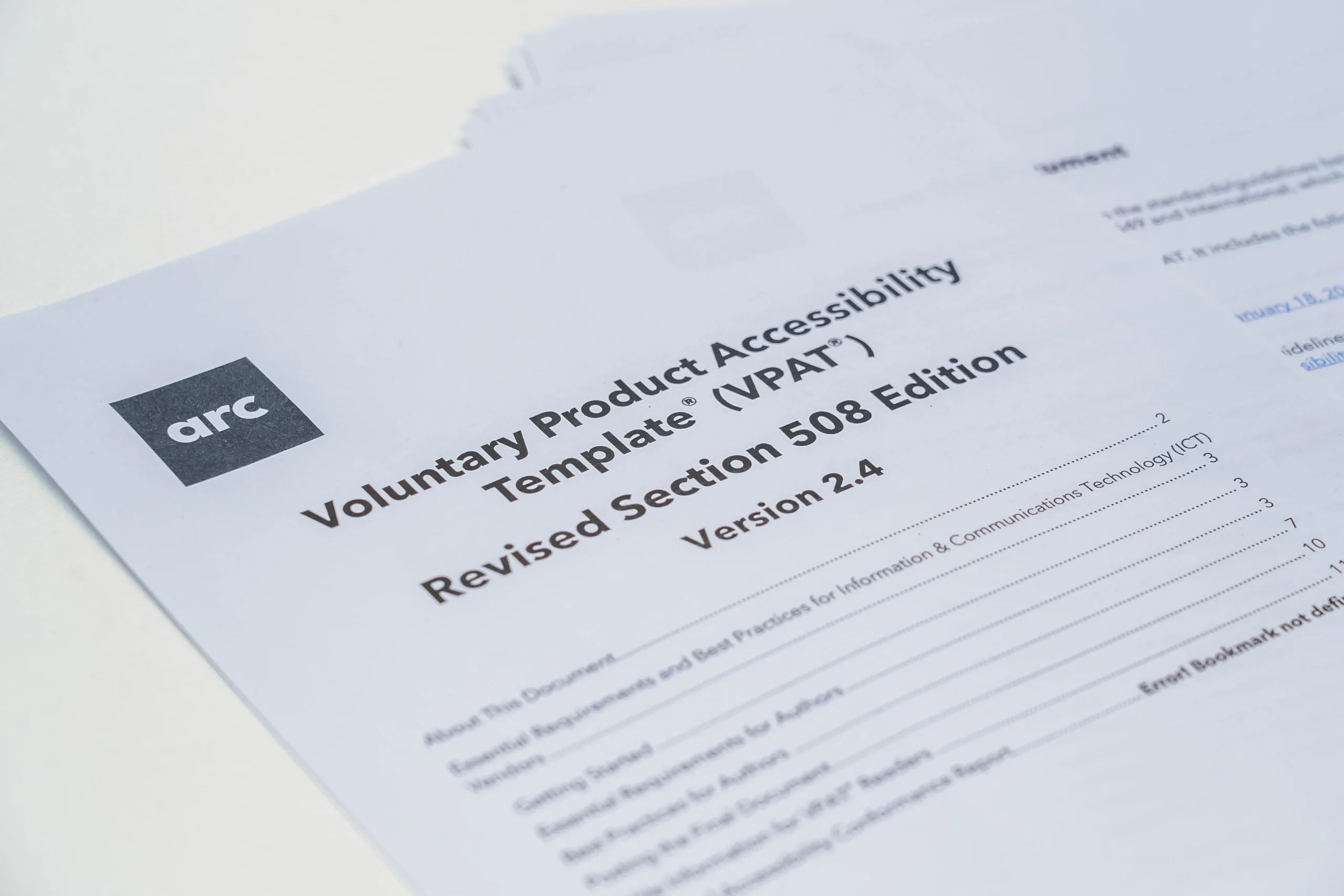 Close-up of a printed Voluntary Product Accessibility Template (VPAT) document from Arc Inclusion, Revised Section 508 Edition, Version 2.4.